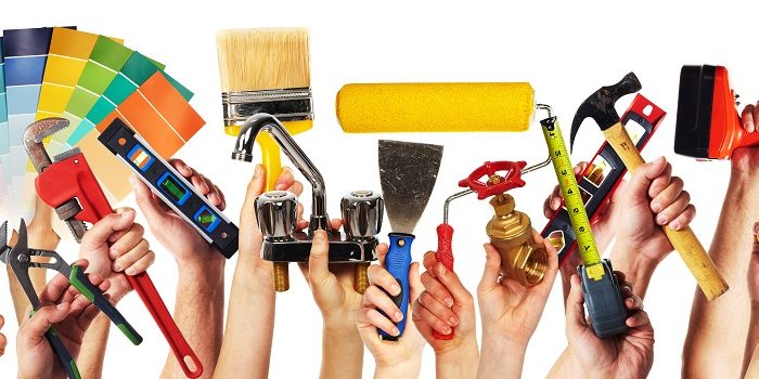 Hands with construction tools.